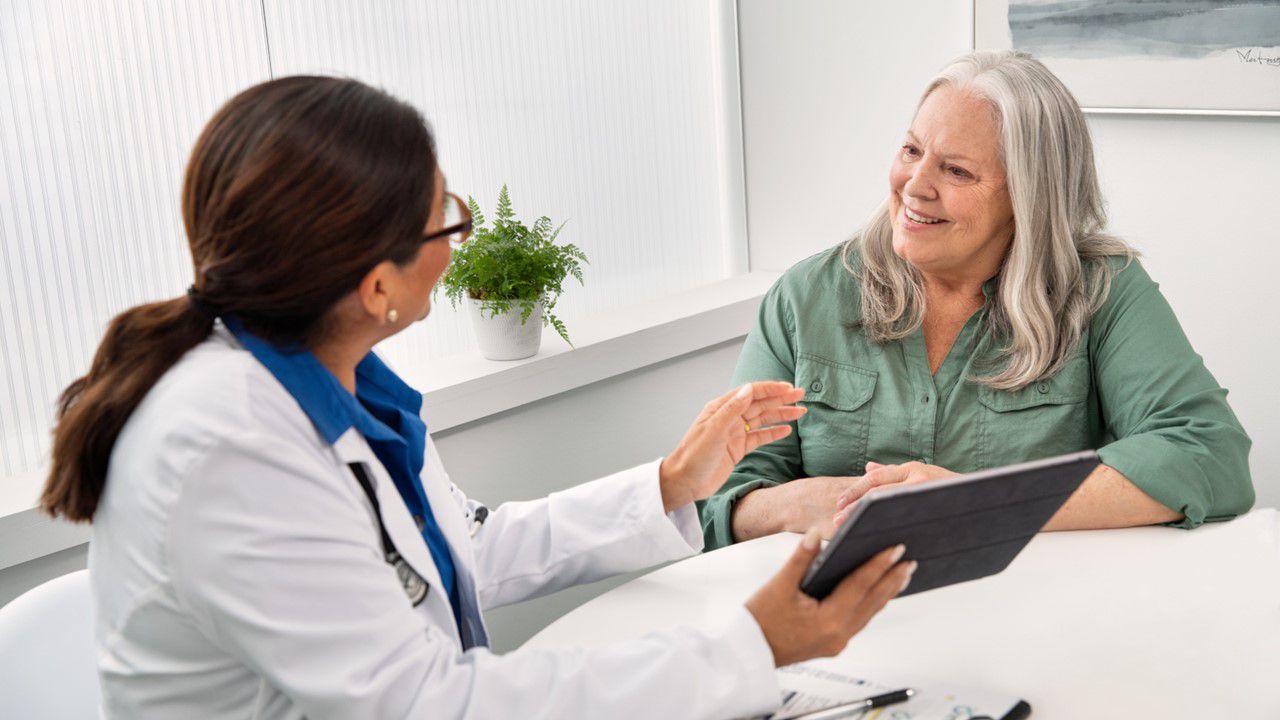 Doctor consulting with older female patient